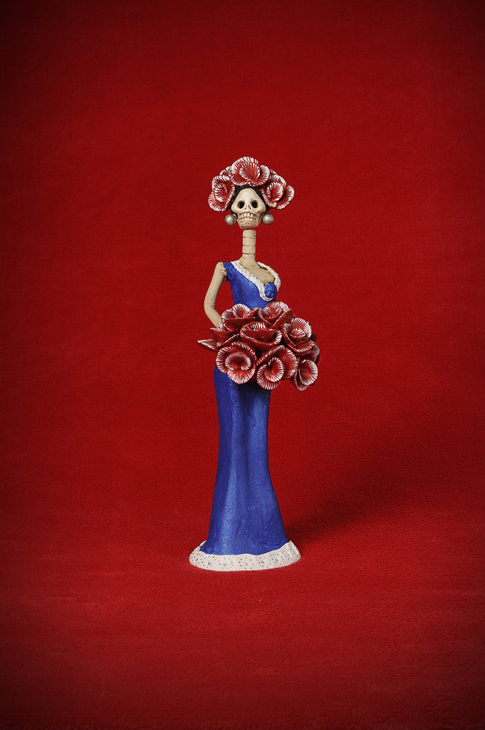  Catrina Mini Miss USA aspires to be like her big sister.   This beautiful mini wears a sleek navy blue gown with a matching flower on her neckline and white trim at the bottom.  We gave her a bouquet and a headpiece with blooming red roses to finish her outfit. She proudly wears these colors to represent her beloved country.  You have to add this beauty to your collection!